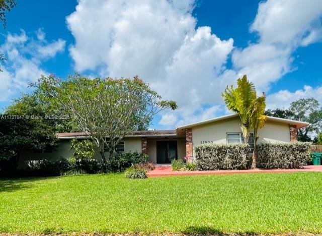 ranch-style home featuring a front yard