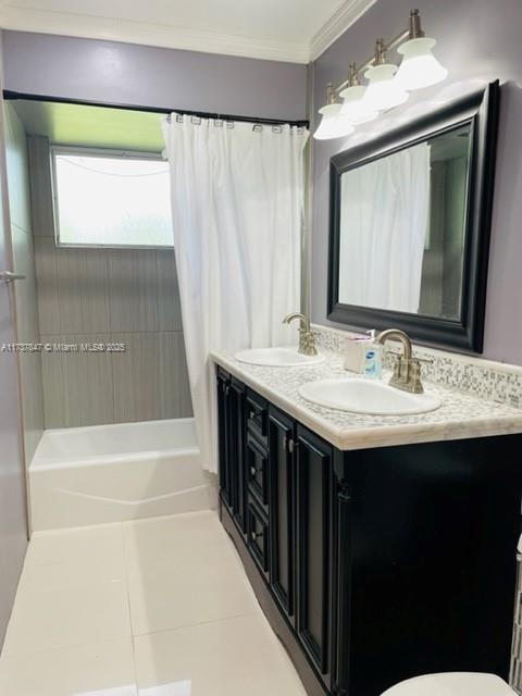 full bathroom with shower / tub combo with curtain, ornamental molding, vanity, toilet, and tile patterned floors