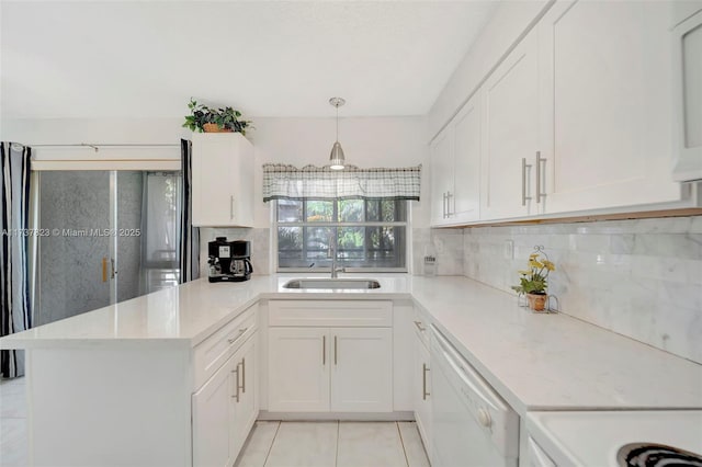 kitchen with hanging light fixtures, white cabinetry, dishwasher, and kitchen peninsula