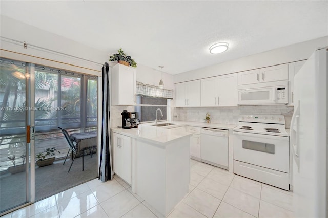 kitchen featuring pendant lighting, sink, white appliances, and white cabinetry