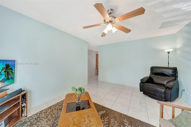 living room with ceiling fan and tile patterned flooring