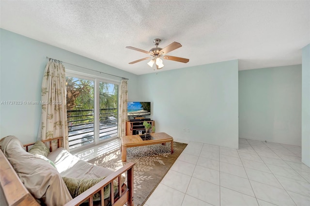 tiled living room featuring a textured ceiling and ceiling fan