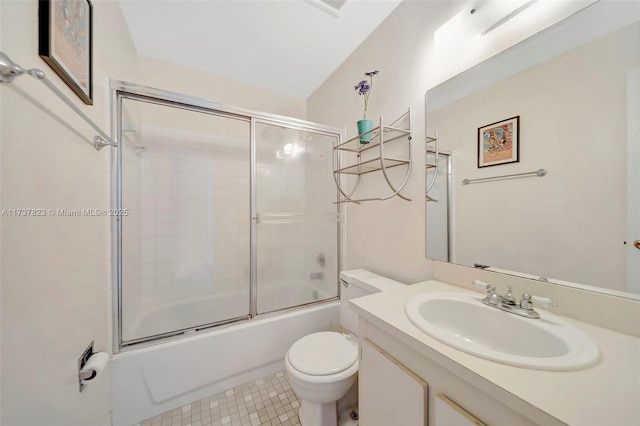 full bathroom with toilet, vanity, bath / shower combo with glass door, and tile patterned flooring