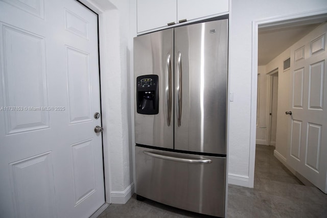 kitchen featuring white cabinets and stainless steel fridge with ice dispenser