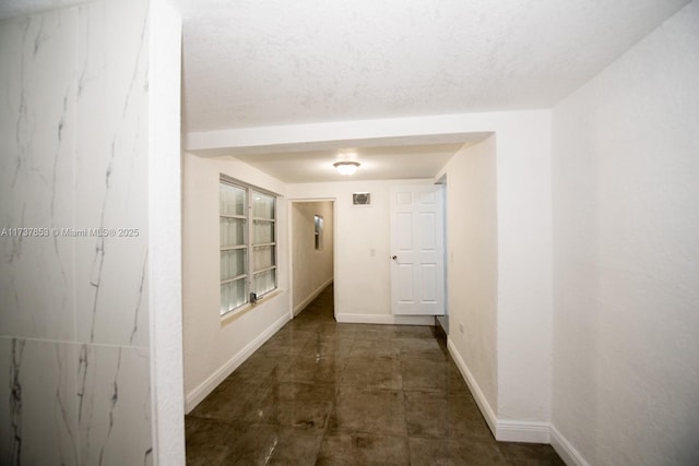 hallway with a textured ceiling