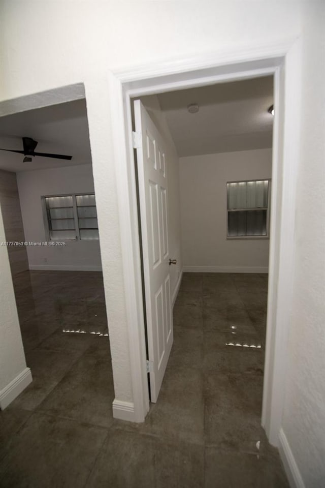 hall featuring dark tile patterned floors