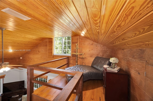 bonus room featuring vaulted ceiling, wood-type flooring, wood ceiling, and wood walls