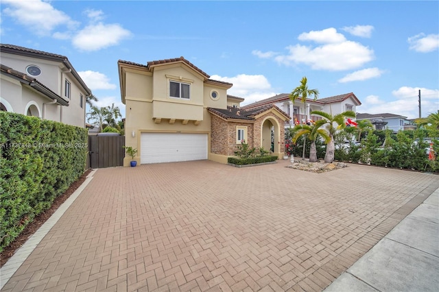 mediterranean / spanish house with a garage