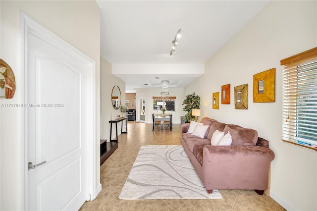 living room with rail lighting and light tile patterned floors