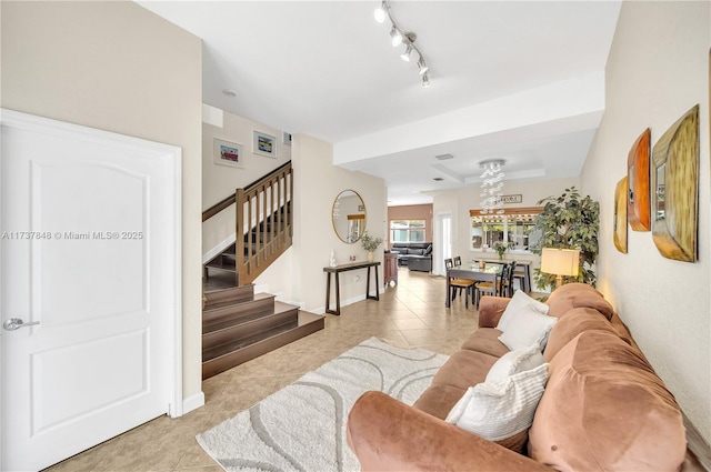 living room featuring track lighting and light tile patterned floors