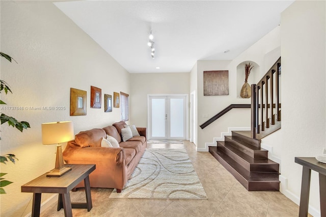 living room featuring french doors, rail lighting, and light tile patterned floors