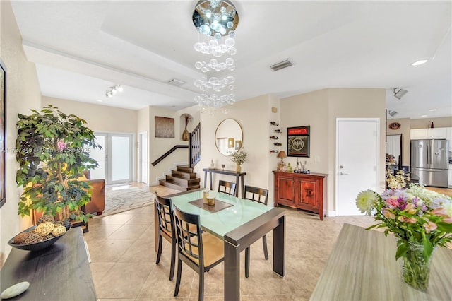 dining area featuring a notable chandelier and light tile patterned floors