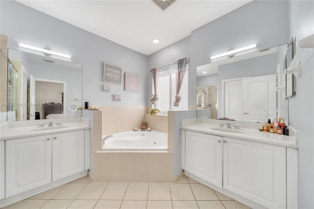 bathroom with tile patterned flooring, vanity, and shower with separate bathtub