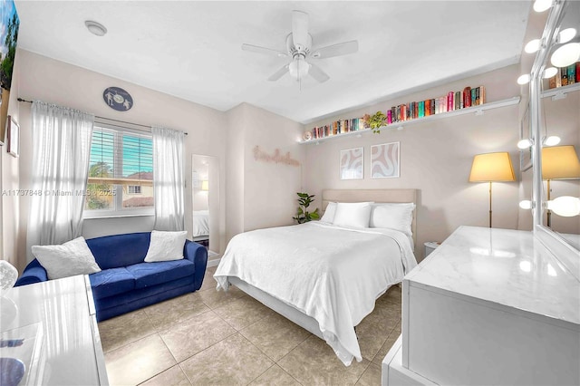 tiled bedroom featuring ceiling fan