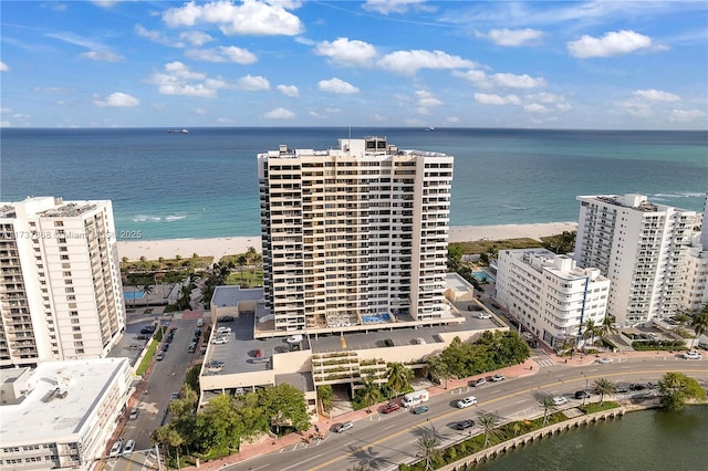 birds eye view of property with a view of the beach and a water view