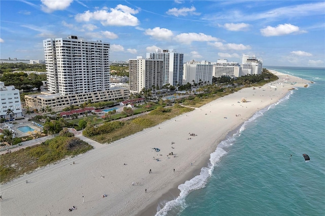 birds eye view of property featuring a water view and a beach view