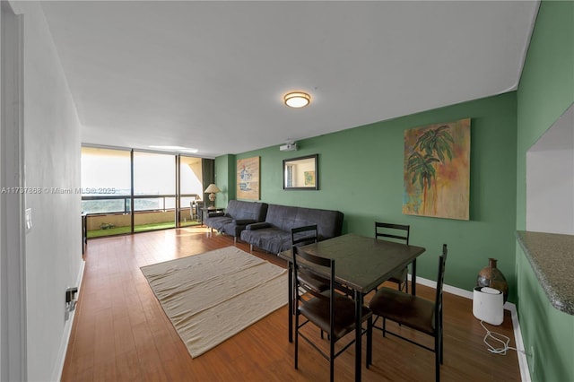 living room featuring floor to ceiling windows and wood-type flooring