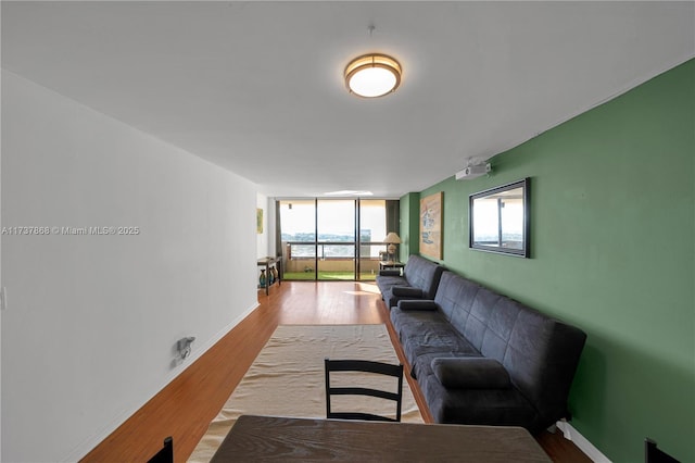 living room with wood-type flooring and floor to ceiling windows