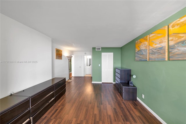 hallway with dark hardwood / wood-style floors