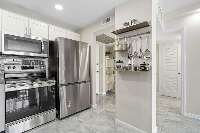 kitchen featuring white cabinetry and appliances with stainless steel finishes