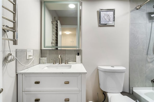 bathroom with vanity, toilet, and backsplash