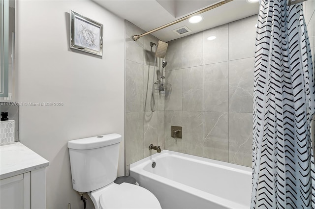 full bathroom with vanity, toilet, and tiled shower / bath combo