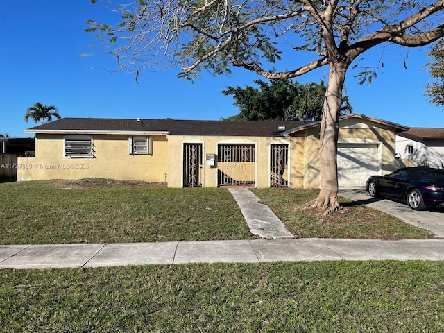 single story home featuring a garage and a front lawn