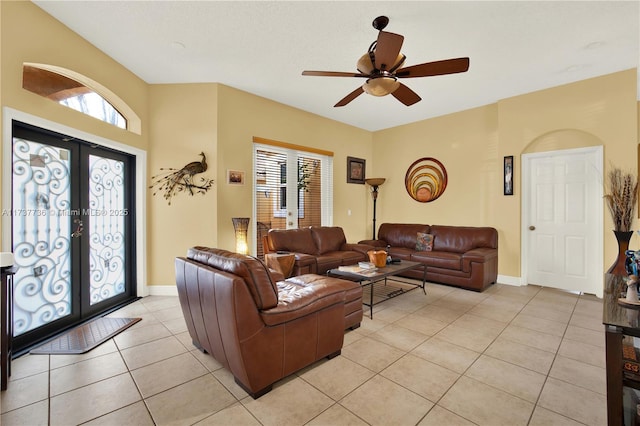 living room featuring light tile patterned floors, french doors, and ceiling fan