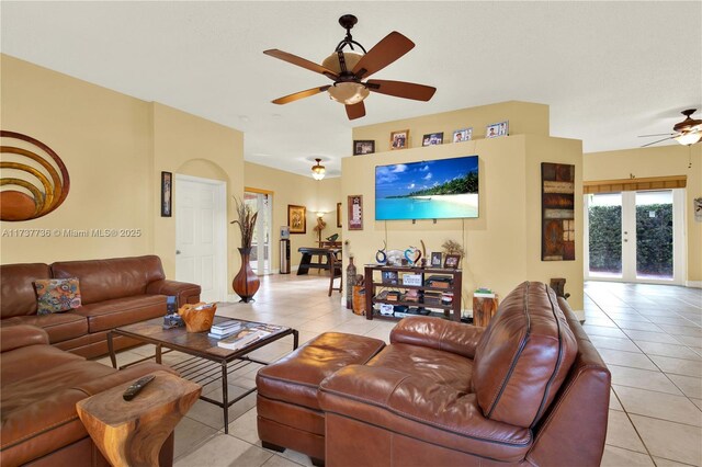 tiled living room with french doors and ceiling fan