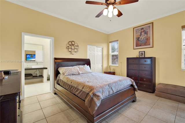 bedroom featuring ornamental molding, light tile patterned floors, ceiling fan, and a closet