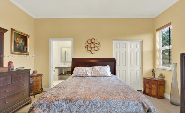 bedroom with crown molding, a closet, and ensuite bathroom