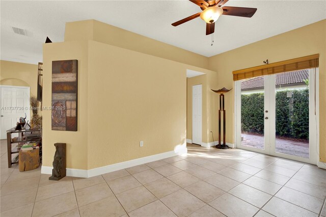 tiled spare room with french doors and ceiling fan