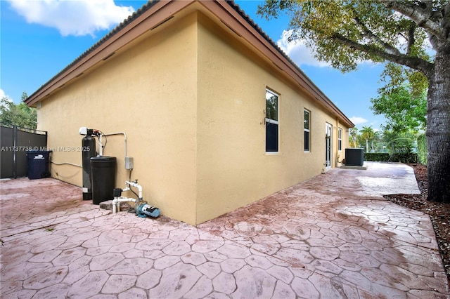 view of side of home featuring central AC and a patio