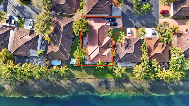 birds eye view of property with a residential view and a water view