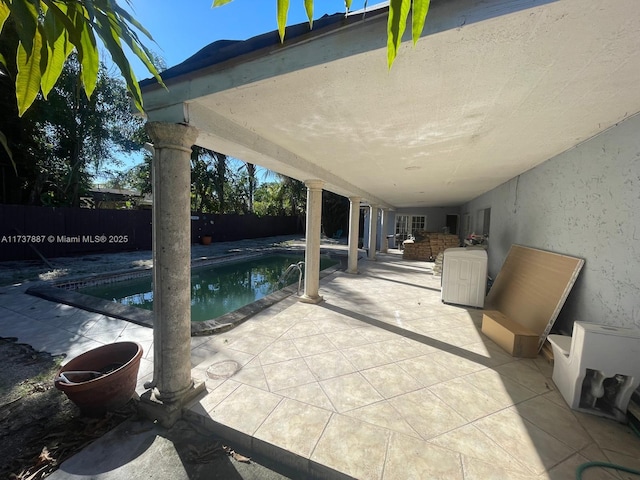 view of patio with a fenced in pool