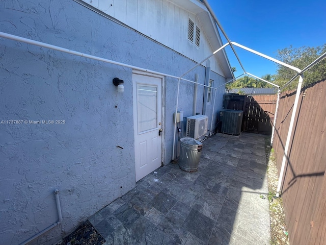 exterior space featuring central AC unit, ac unit, and a patio