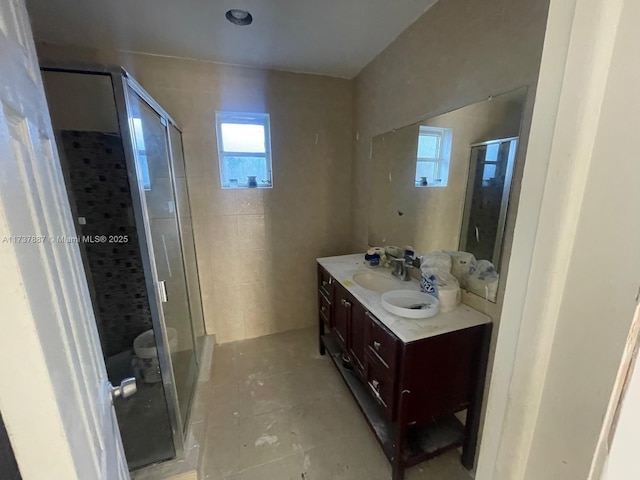 bathroom with vanity, an enclosed shower, and tile patterned floors