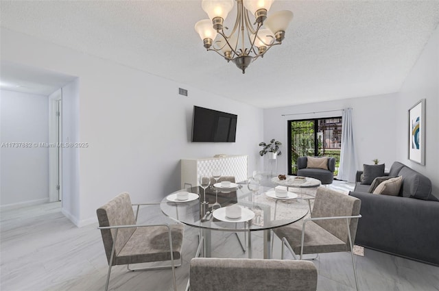 dining room featuring a notable chandelier and a textured ceiling