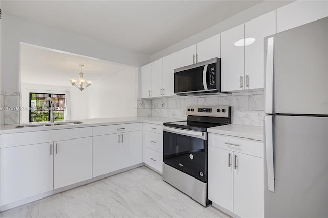 kitchen with white cabinetry, sink, tasteful backsplash, and appliances with stainless steel finishes