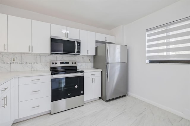 kitchen with tasteful backsplash, white cabinetry, and appliances with stainless steel finishes