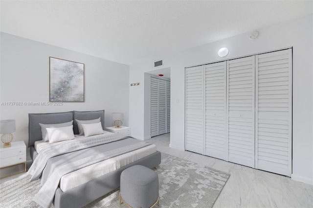 bedroom with a closet and a textured ceiling