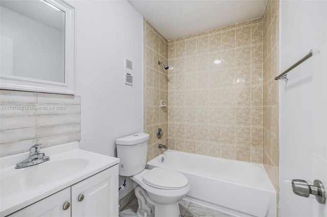 full bathroom featuring tiled shower / bath combo, vanity, and toilet