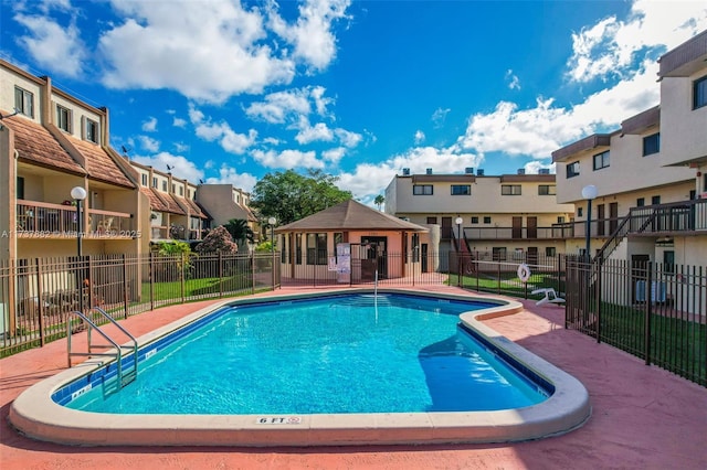 view of swimming pool featuring a patio and a gazebo