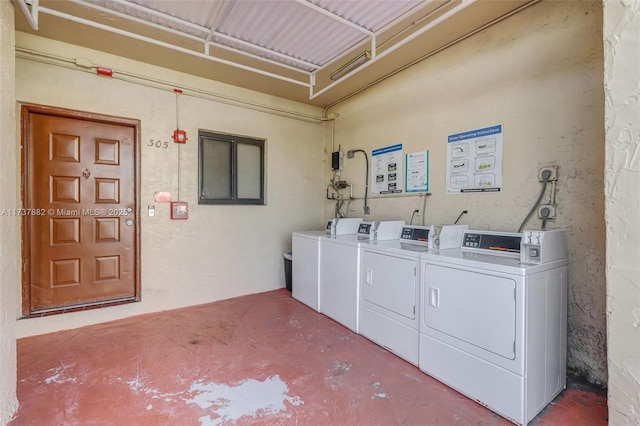 clothes washing area with separate washer and dryer