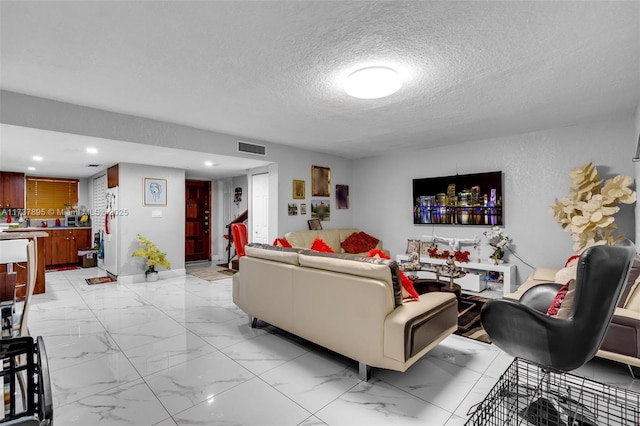 living room featuring a textured ceiling