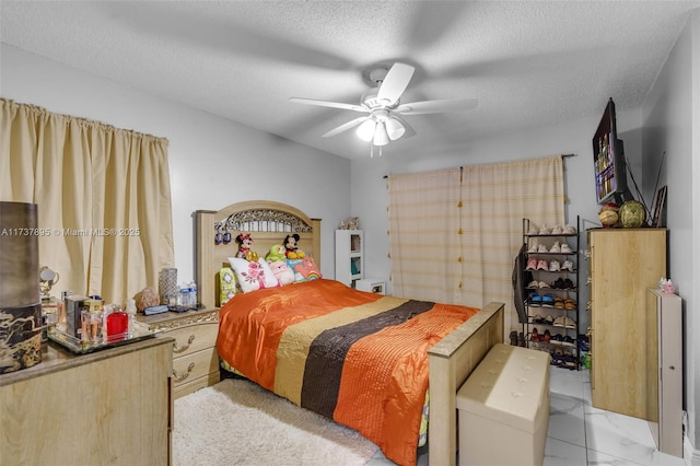 bedroom with ceiling fan and a textured ceiling