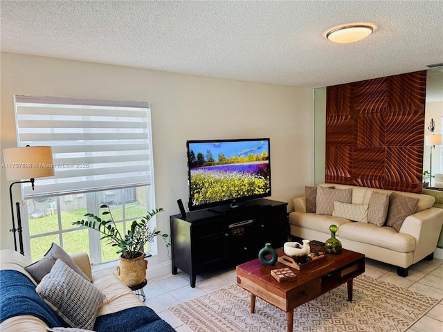 living room featuring a textured ceiling and light tile patterned flooring