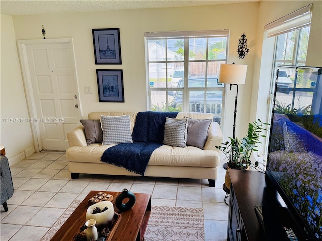 tiled living room with plenty of natural light and a textured ceiling