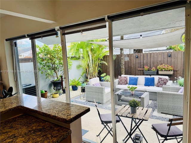 view of patio / terrace with central AC, an outdoor hangout area, and a pergola