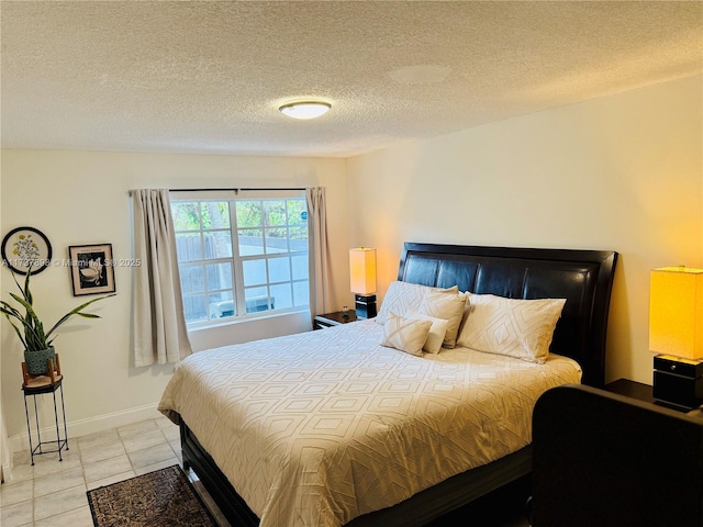 tiled bedroom featuring a textured ceiling